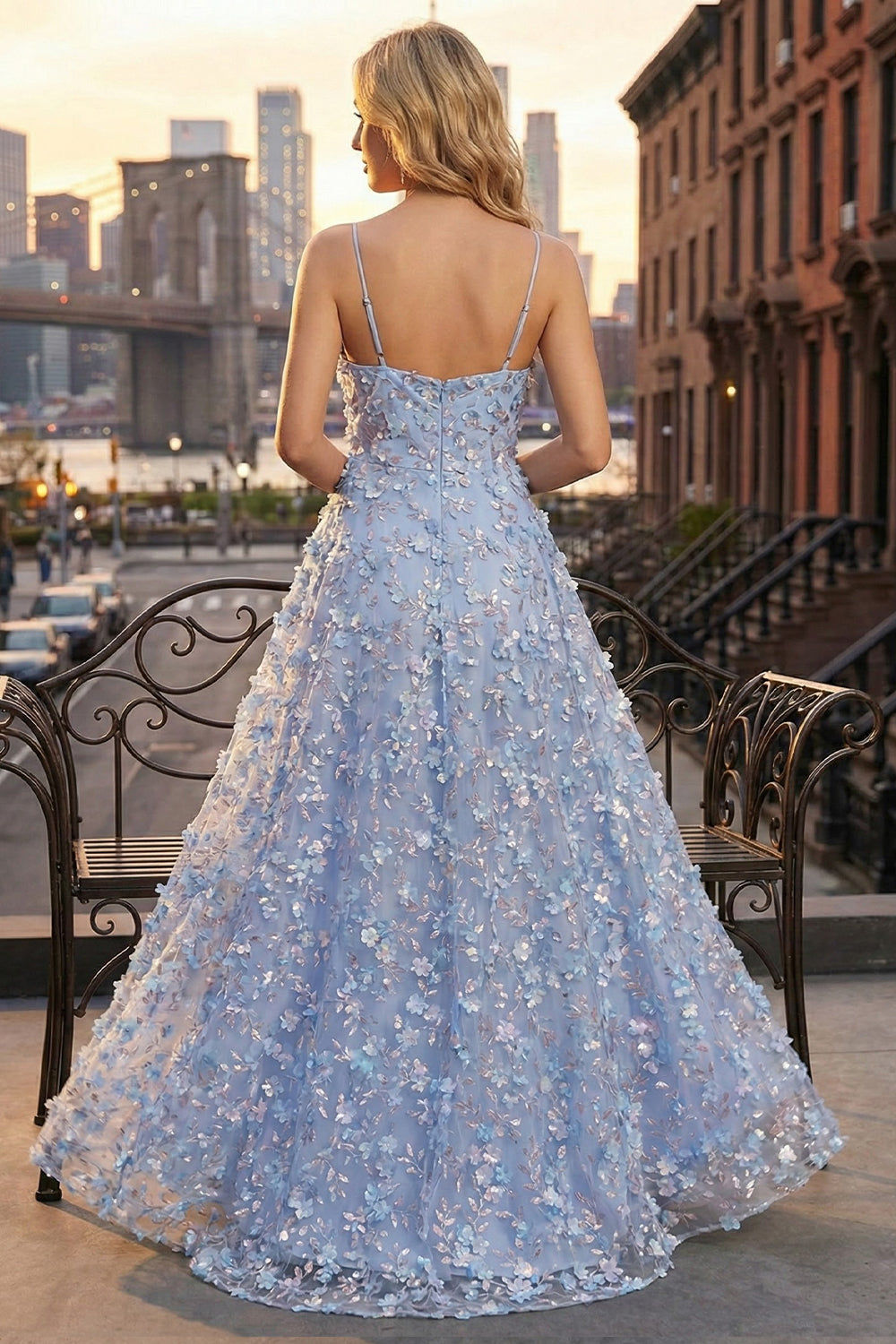 Back view of Sevoba periwinkle blue floral evening gown showing a zipper closure and voluminous flowy skirt, urban street background