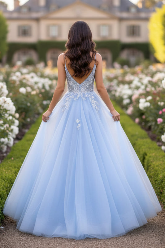 Back view of Sevoba light blue beaded lace evening gown showing a V-back and voluminous tulle skirt, outdoor background