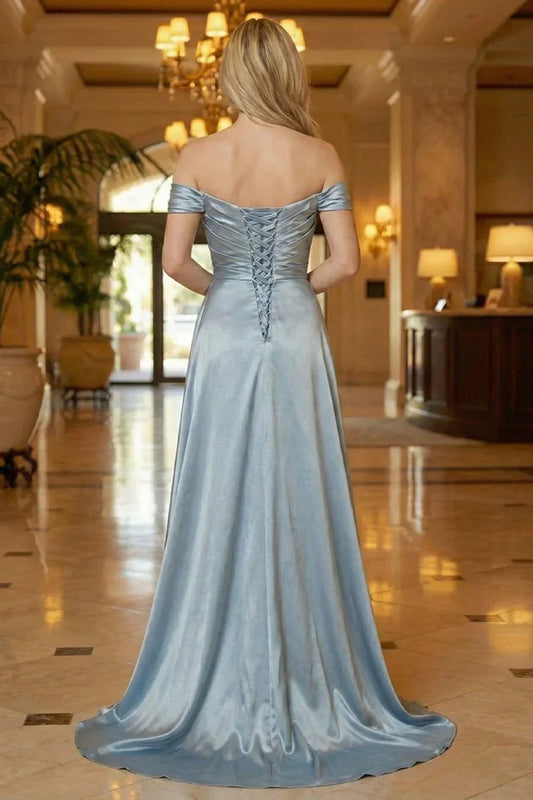 Back view of Sevoba dusty blue satin evening gown showing a lace-up corset back and ruched detailing, indoor lobby setting