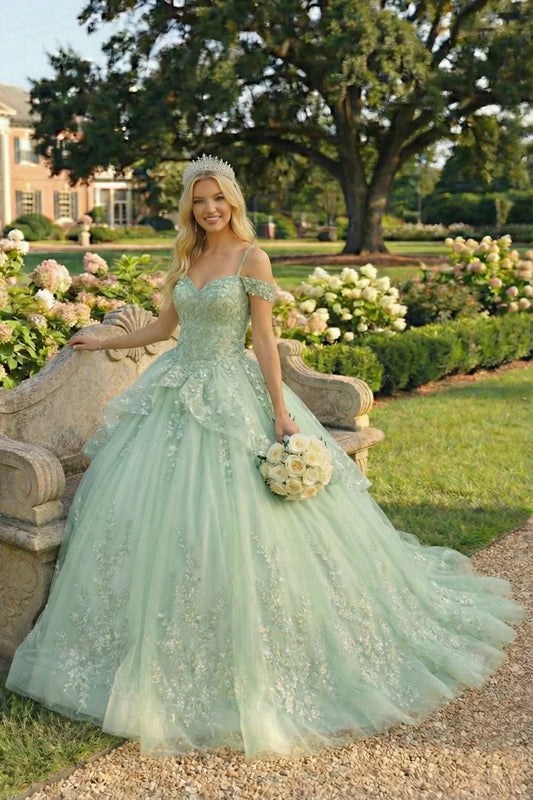 Elegant ball gown quinceañera dress with floral embroidery and crown in a garden