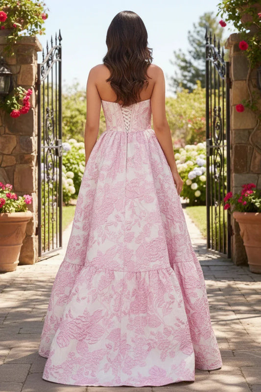 Sevoba pink strapless corset floral ball gown prom dress with lace-up back and full skirt, back view in garden gate setting