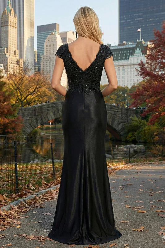 Back view of Sevoba black beaded lace satin evening gown featuring a V-back and invisible zipper closure, outdoor park background