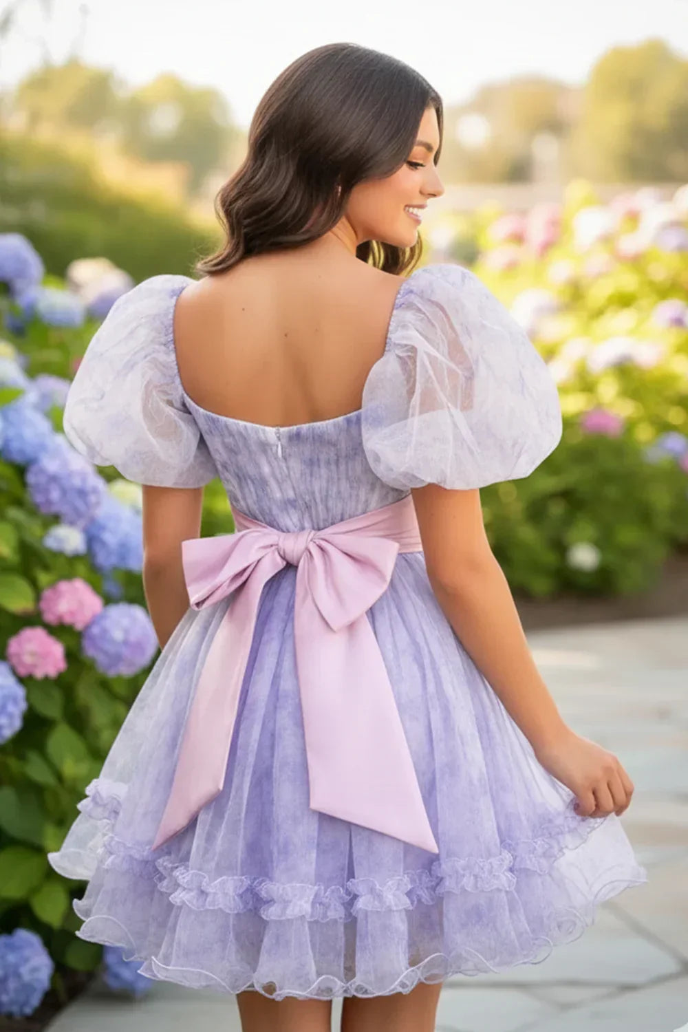 Lilac A-line short homecoming dress with puff sleeves and pink bow, outdoor garden setting