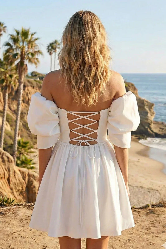 A-line satin short homecoming dress with puffed sleeves and lace-up back on beach