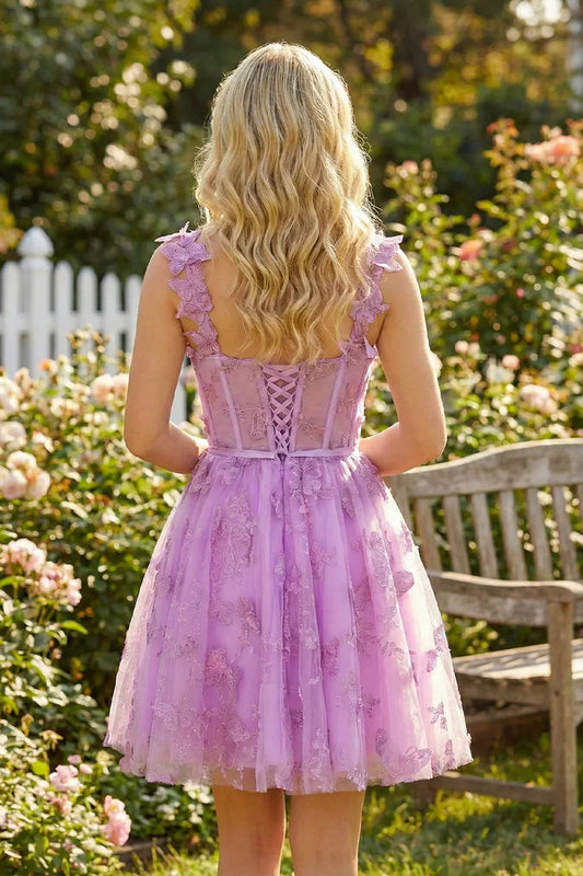 Back view of a woman in a lilac short tulle homecoming dress with 3D butterfly details in a garden.