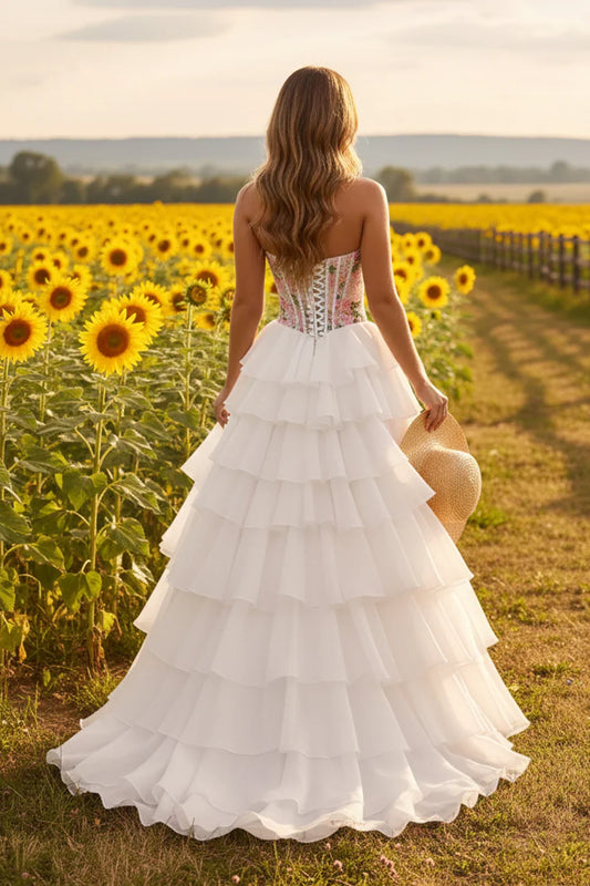 Sevoba strapless floral corset tiered A-line prom dress with lace-up back, back view in sunflower field