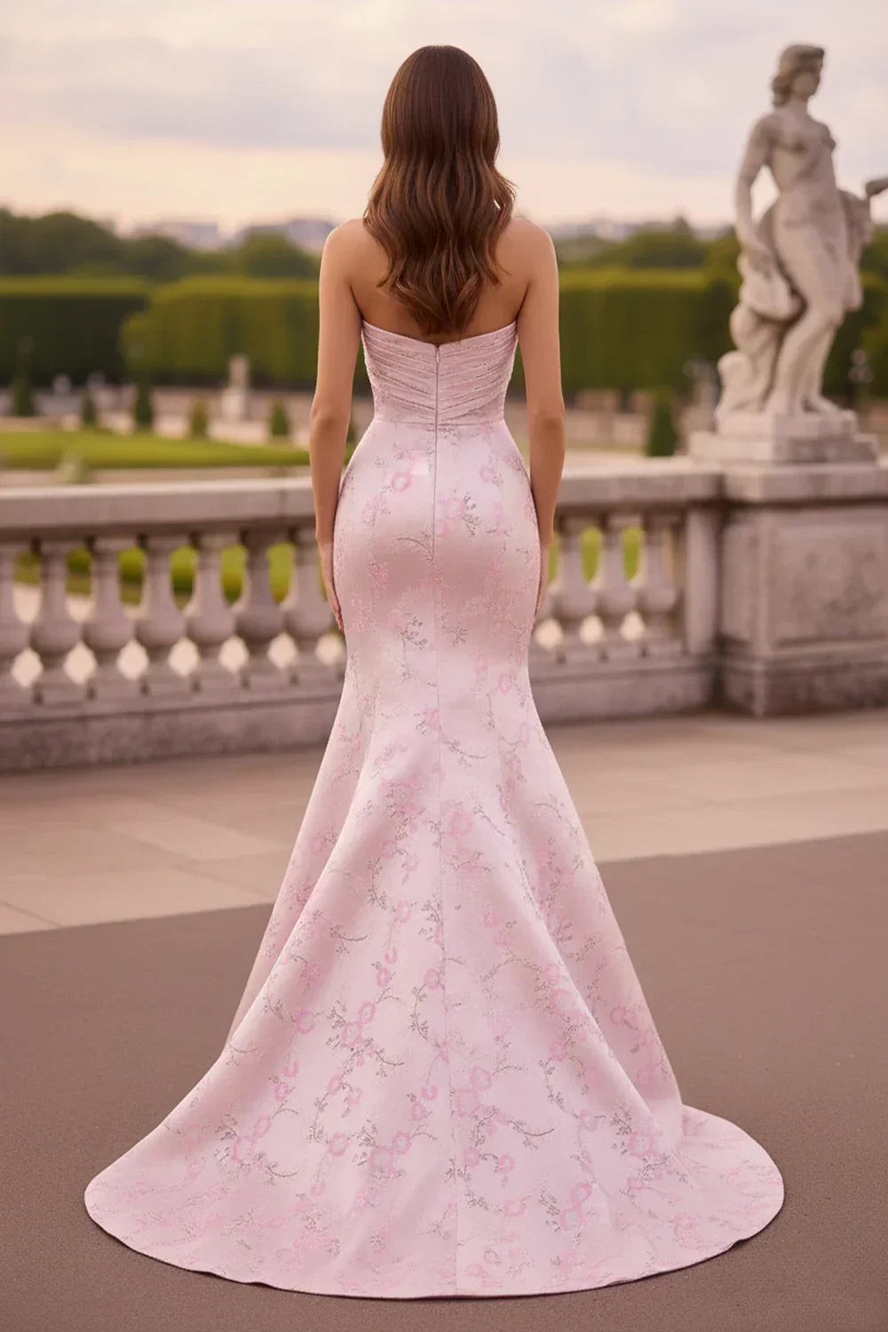 Back view of long A-line sweetheart prom dress with floral embroidery outdoors