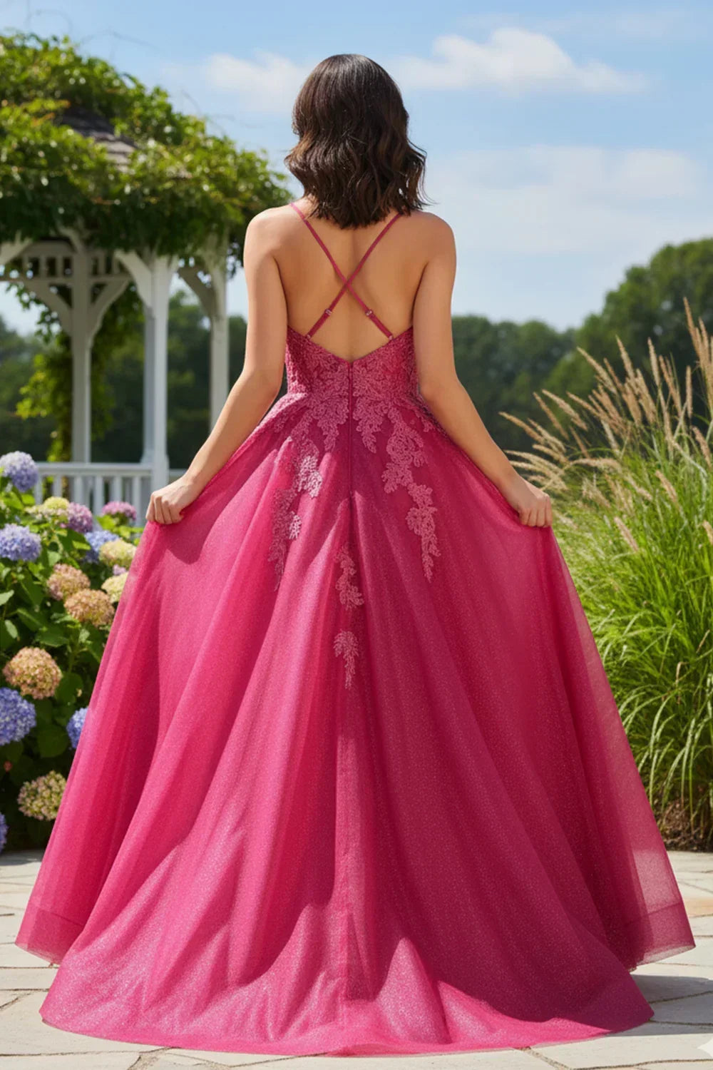 Woman in pink lace A-line long prom dress with crisscross straps outdoors