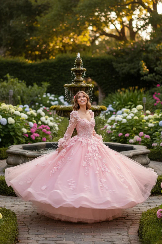 Woman in a pink long sleeve ball gown with floral lace, twirling near a garden fountain
