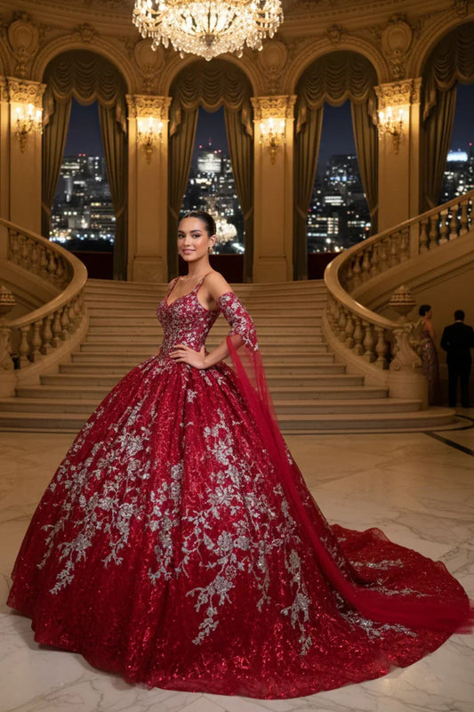 Woman in a red off-the-shoulder tulle ball gown with silver embroidery in a grand ballroom