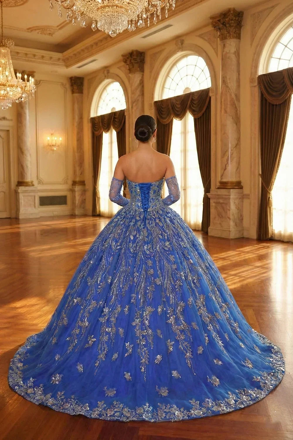 Blue glittery ball gown quinceañera dress with sheer sleeves in elegant ballroom