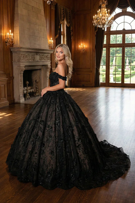 Woman in black 3D floral ball gown dress with train, posing in elegant formal hall