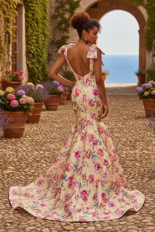 Woman wearing a deep V-neck mermaid prom dress with pink floral print outdoors