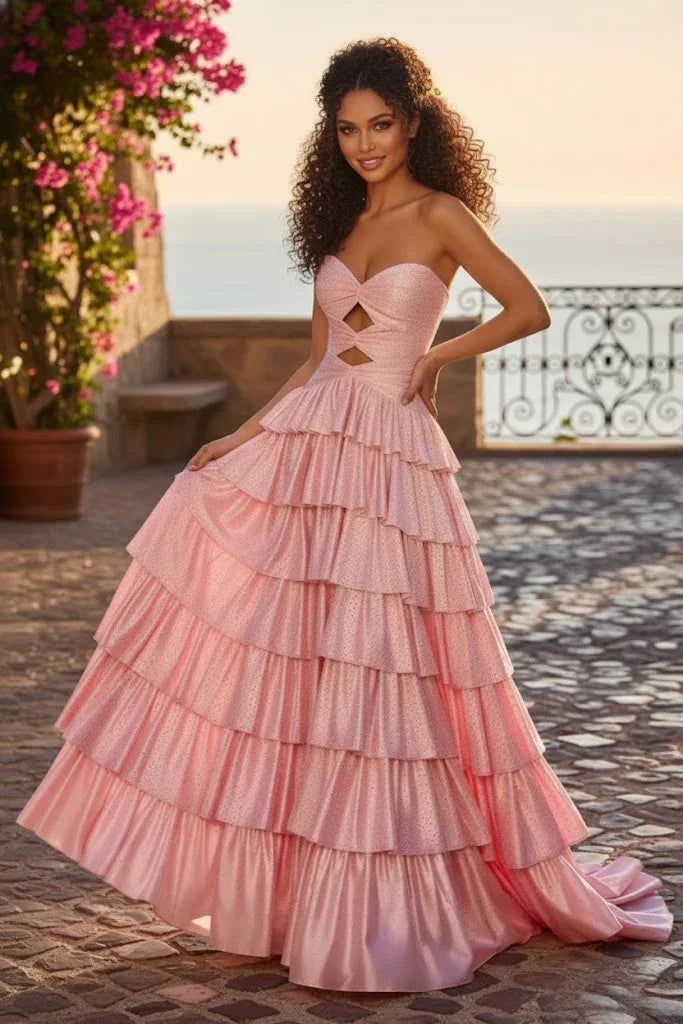 Woman wearing pink sparkly sweetheart A-line prom dress with tiered ruffles and keyhole bodice