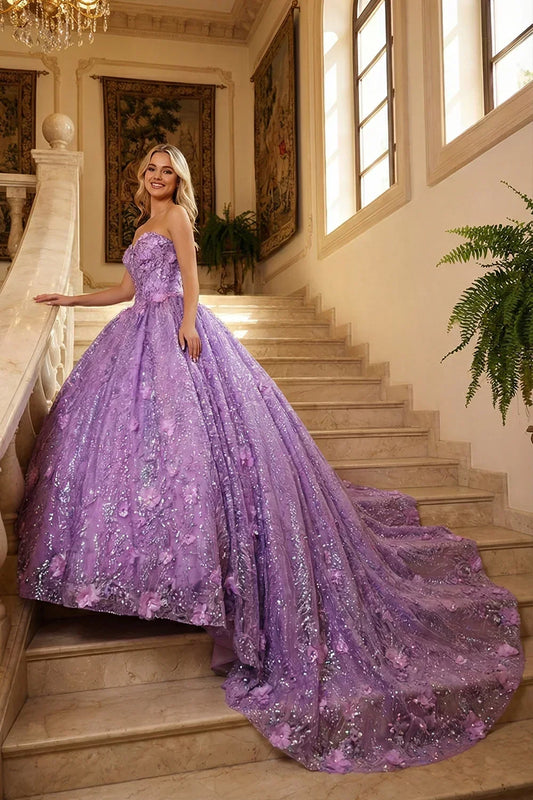 Woman in a strapless lavender ball gown with floral embroidery and sequins on a marble staircase