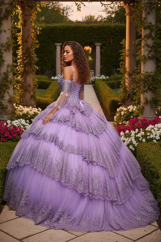 Woman in a lavender layered ruffled ball gown with embroidery in a garden setting