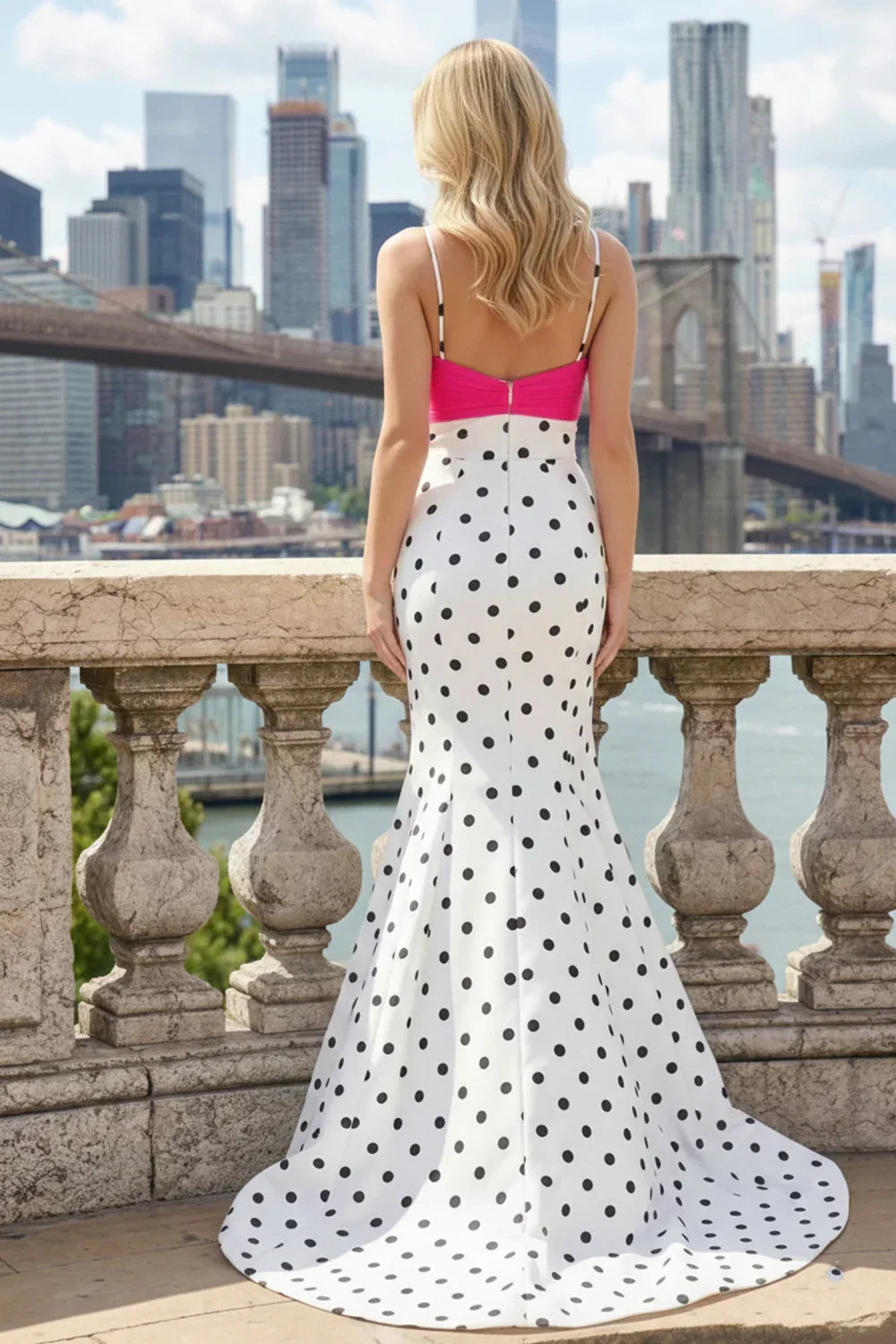 Woman in a mermaid V-neck polka dot prom dress with pink corset, city skyline background