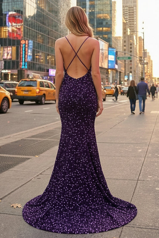 Back view of Sevoba deep purple sequin evening gown showing a criss-cross open back and sweep train, city street background