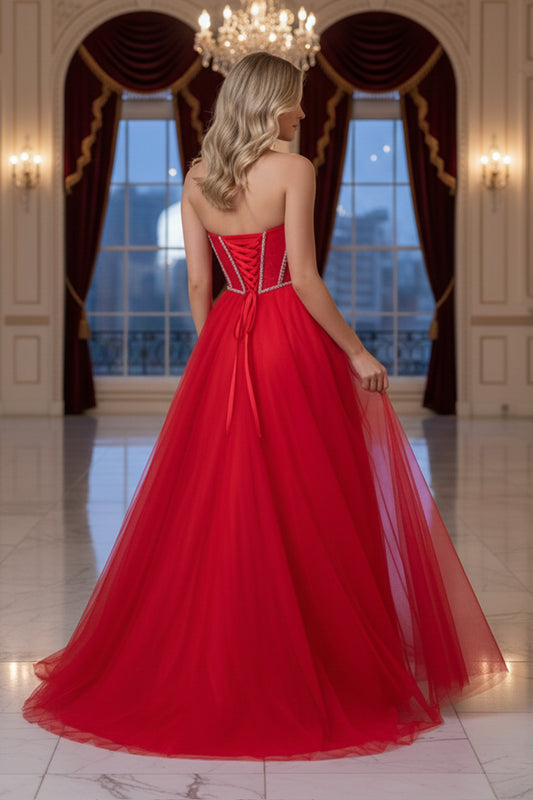 Back view of Sevoba red tulle A-line evening gown showing a lace-up corset back and floor-length skirt, ballroom background