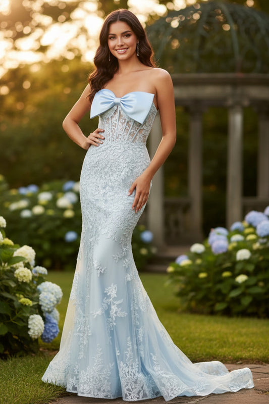 Sevoba bow-front strapless lace corset mermaid prom dress with lace appliqués and floor-length sweep, front view in garden at golden hour
