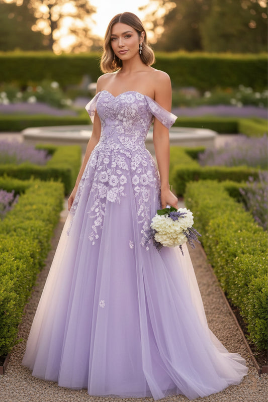 Sevoba lilac tulle A-line prom dress featuring off-the-shoulder draped sleeves and white floral lace appliqués, front view in lavender garden setting