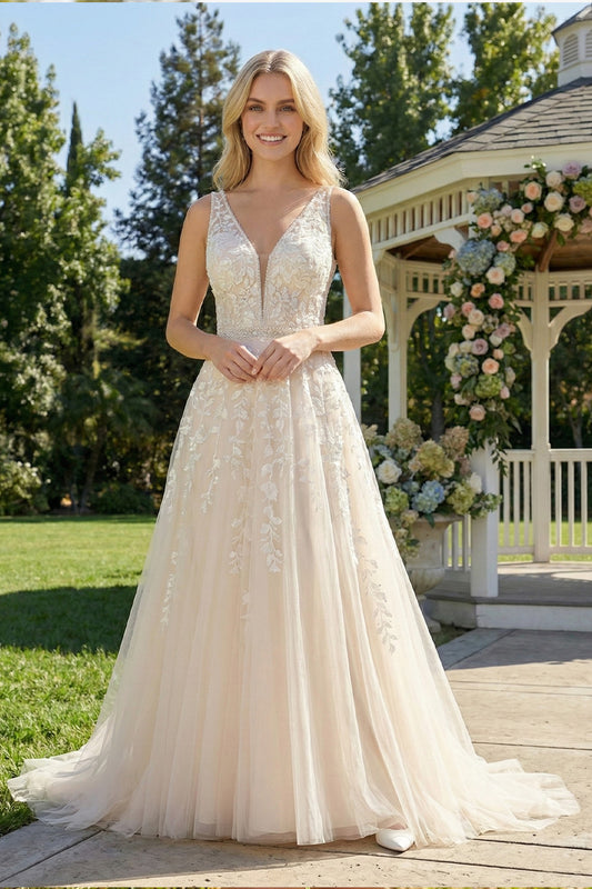 Sevoba champagne tulle A-line wedding dress featuring a V-neckline with mesh insert and leafy lace appliques, front view in outdoor garden setting