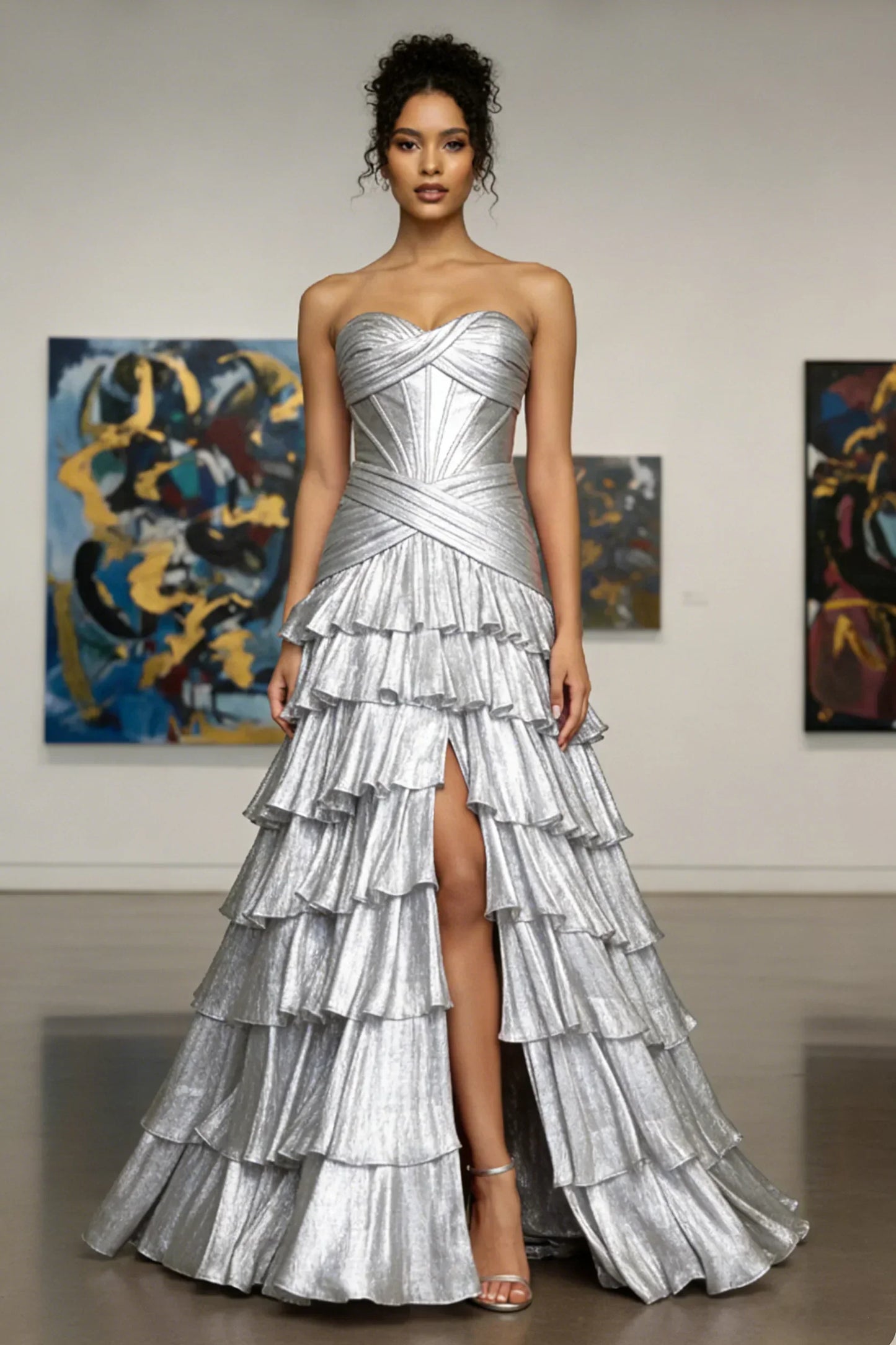 Woman in a strapless silver ruffle evening gown with a high slit, standing in art gallery