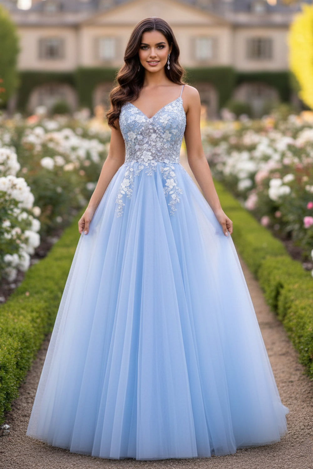 Sevoba light blue tulle A-line prom dress featuring silver beaded floral lace bodice and spaghetti straps, front view in garden setting