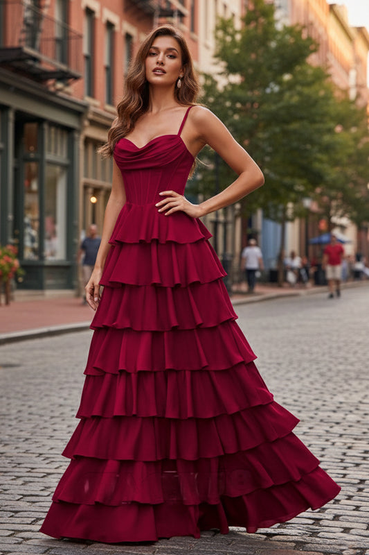 Sevoba burgundy tiered ruffle prom dress featuring a cowl neckline and structured corset bodice, front view in urban street setting