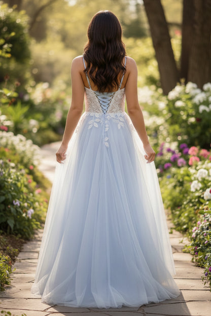 Back view of Sevoba light blue lace tulle evening gown showing a lace-up corset back and flowy floor-length skirt, garden path background
