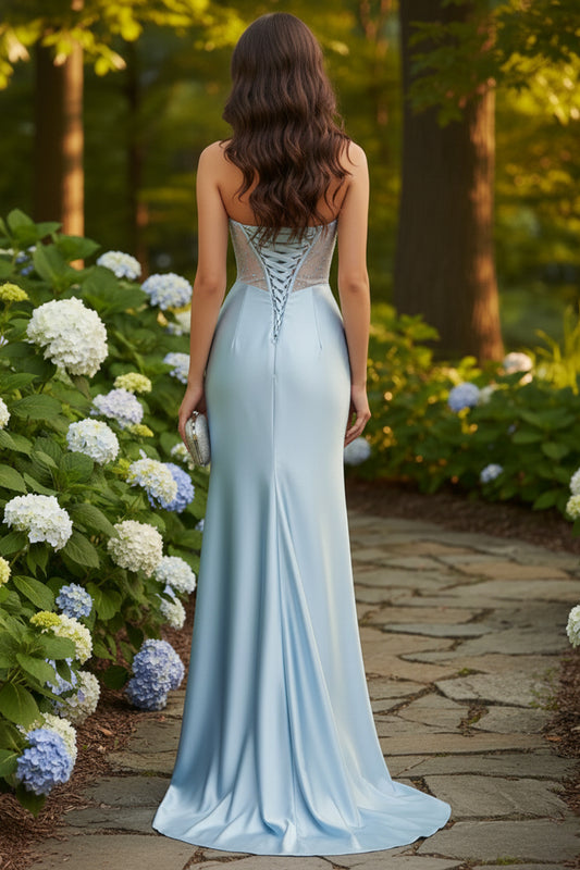 Sevoba strapless beaded cup illusion corset mermaid prom dress in light icy blue with lace-up back and fitted satin silhouette, back view outdoors, camera-ready look