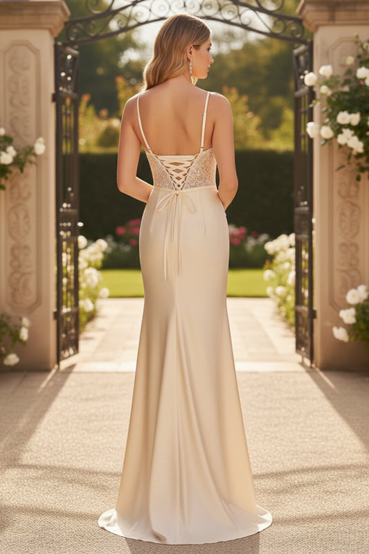Back view of Sevoba ivory lace and satin evening gown showing a lace-up corset back and fitted floor-length skirt, garden gate background