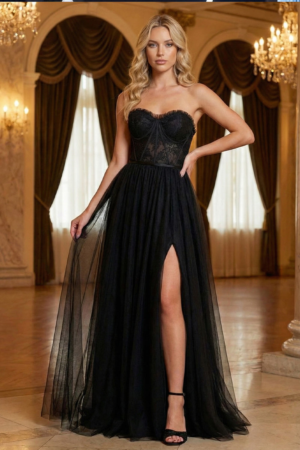 Sevoba strapless black tulle prom dress featuring a sheer lace corset bodice with ruffled trim and a high leg slit, front view in ballroom setting