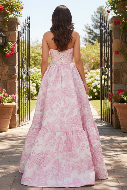 Sevoba pink strapless corset floral ball gown prom dress with lace-up back and full skirt, back view in garden gate setting
