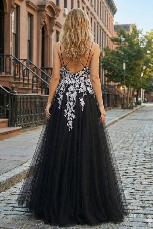 Back view of Sevoba black and white floral tulle prom dress showing a low back and zipper closure, street setting