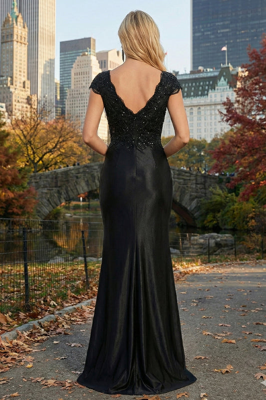 Back view of Sevoba black beaded lace satin evening gown featuring a V-back and invisible zipper closure, outdoor park background
