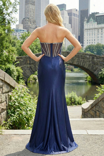 Back view of Sevoba navy blue strapless corset prom dress showing sheer back panels with embellished boning and zipper closure, outdoor bridge background