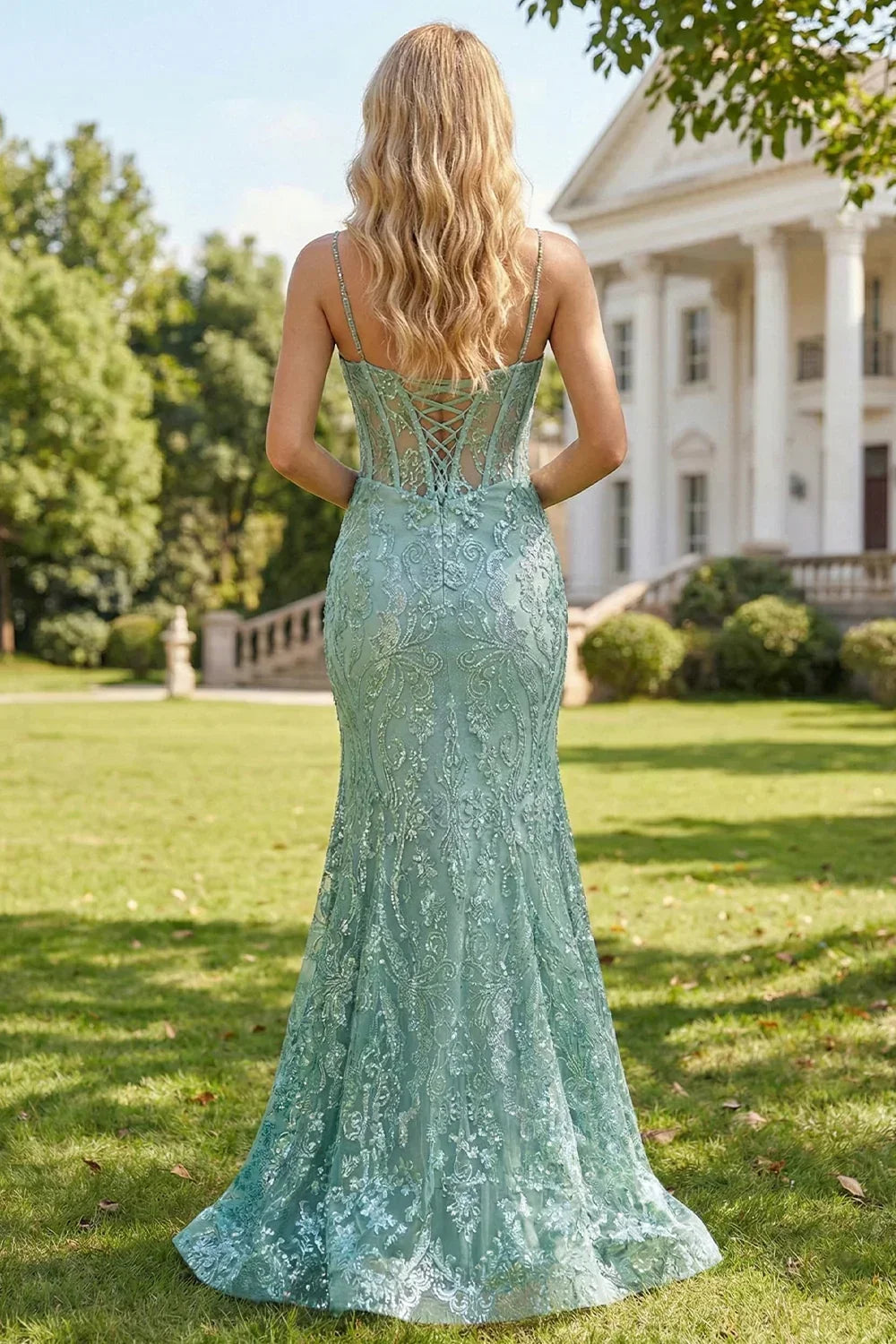 Back view of Sevoba sage green patterned sequin evening gown showing a lace-up corset back and fitted mermaid silhouette, outdoor background
