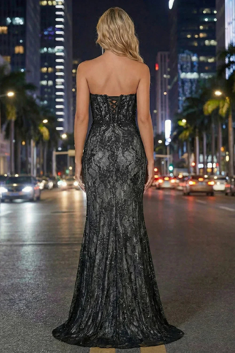 Sevoba black grey strapless corset lace mermaid prom dress with lace-up back and floor-length sweep, back view on city street at night