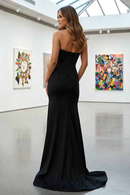 Woman in a strapless black evening gown standing in a modern art gallery