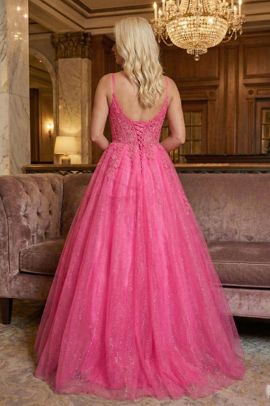 Back view of Sevoba hot pink sparkly tulle evening gown showing a lace-up corset back and floor-length skirt, hotel background