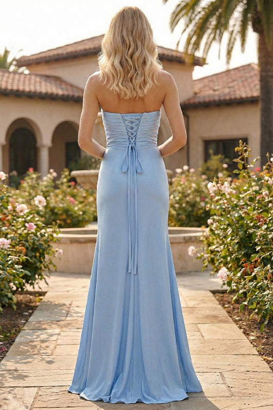 Back view of Sevoba light blue satin evening gown showing a lace-up corset back and ruched bodice, garden background