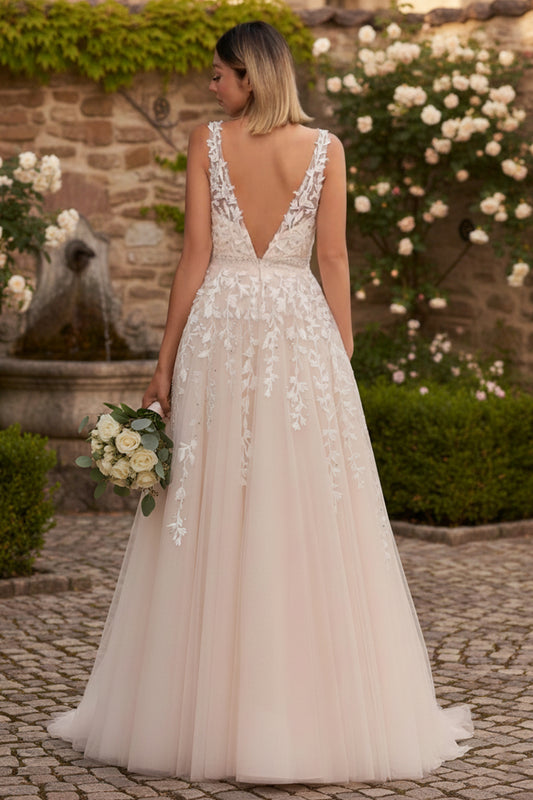 Sevoba ivory applique lace tulle A-line prom dress with low V back and sweep train, back view in garden courtyard
