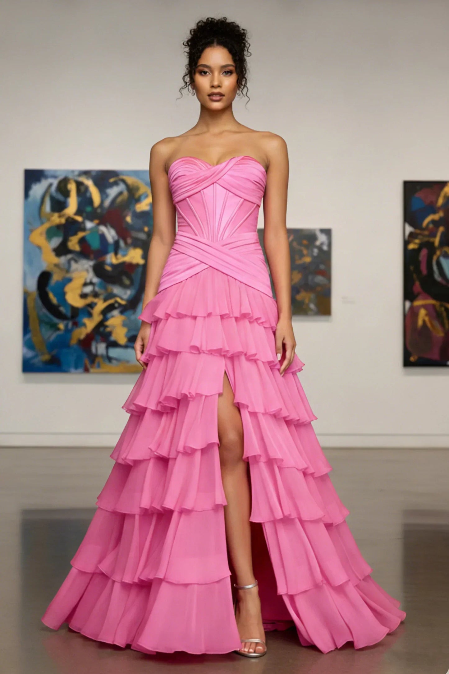 Woman in strapless pink tiered ruffle gown with side slit, ideal for prom or formal events