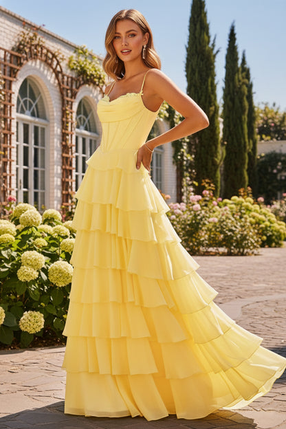 Sevoba yellow tiered ruffle prom dress featuring a corset bodice with 3D floral neckline details and spaghetti straps, front view in garden setting