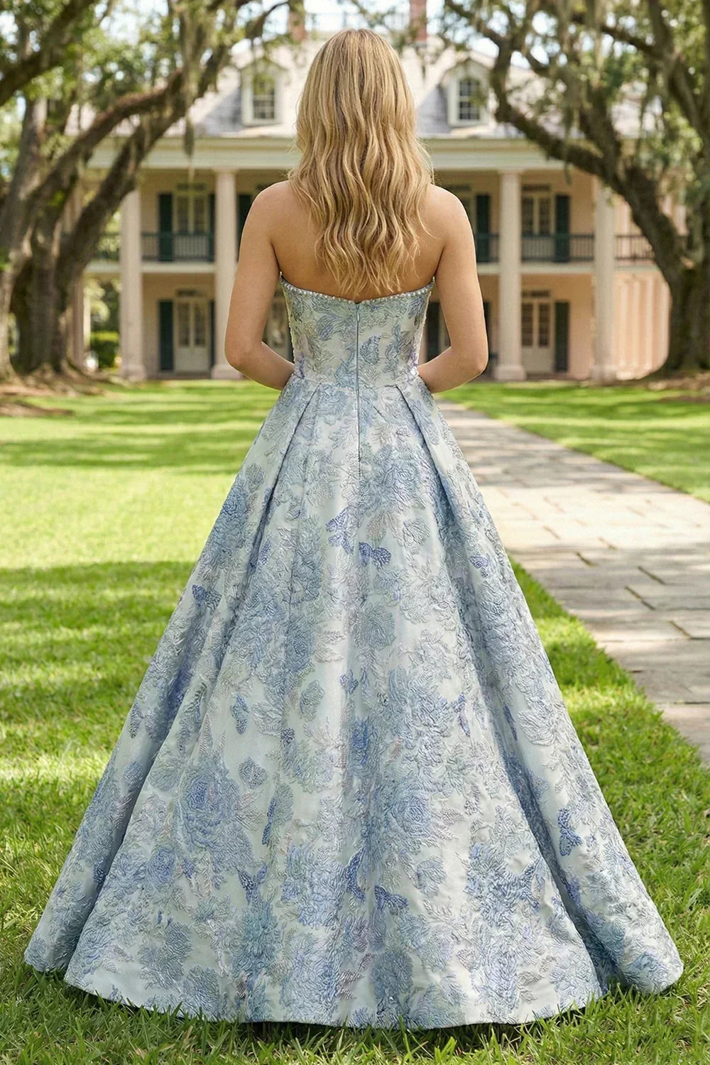 A-line strapless long prom dress in blue jacquard fabric with floral pattern, outdoor setting