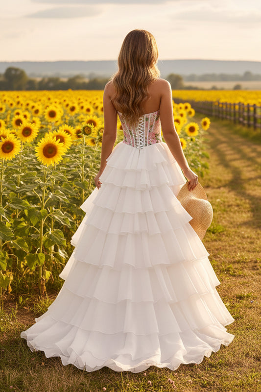 Sevoba strapless floral corset tiered A-line prom dress with lace-up back, back view in sunflower field