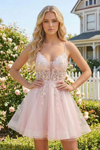 Woman wearing a pink A-line V-neck illusion homecoming dress with floral appliques outdoors