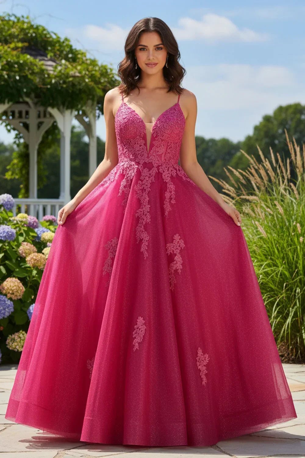 Woman wearing a pink A-line V-neck lace prom dress outdoors near flowers and a garden gazebo