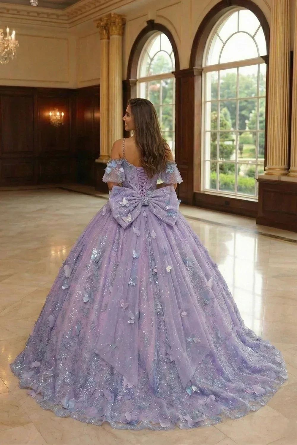Lavender ball gown with 3D butterfly appliques, large bow, and embroidery in elegant room